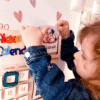 Colorful wooden calendar toy for kids with movable parts for learning days, months, emotions, and seasons.